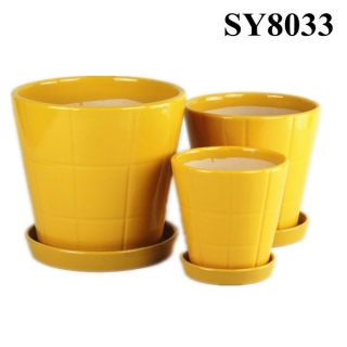 grid on yellow glazed ceramic flower pot