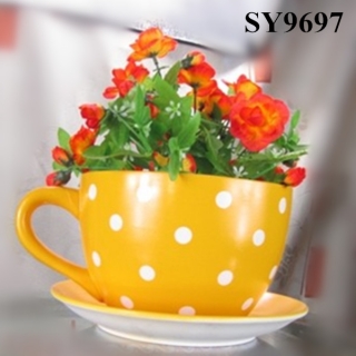 Ceramic yellow tea cup and saucer flower pot
