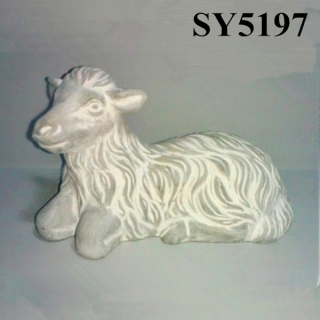 Squating small goat garden statue